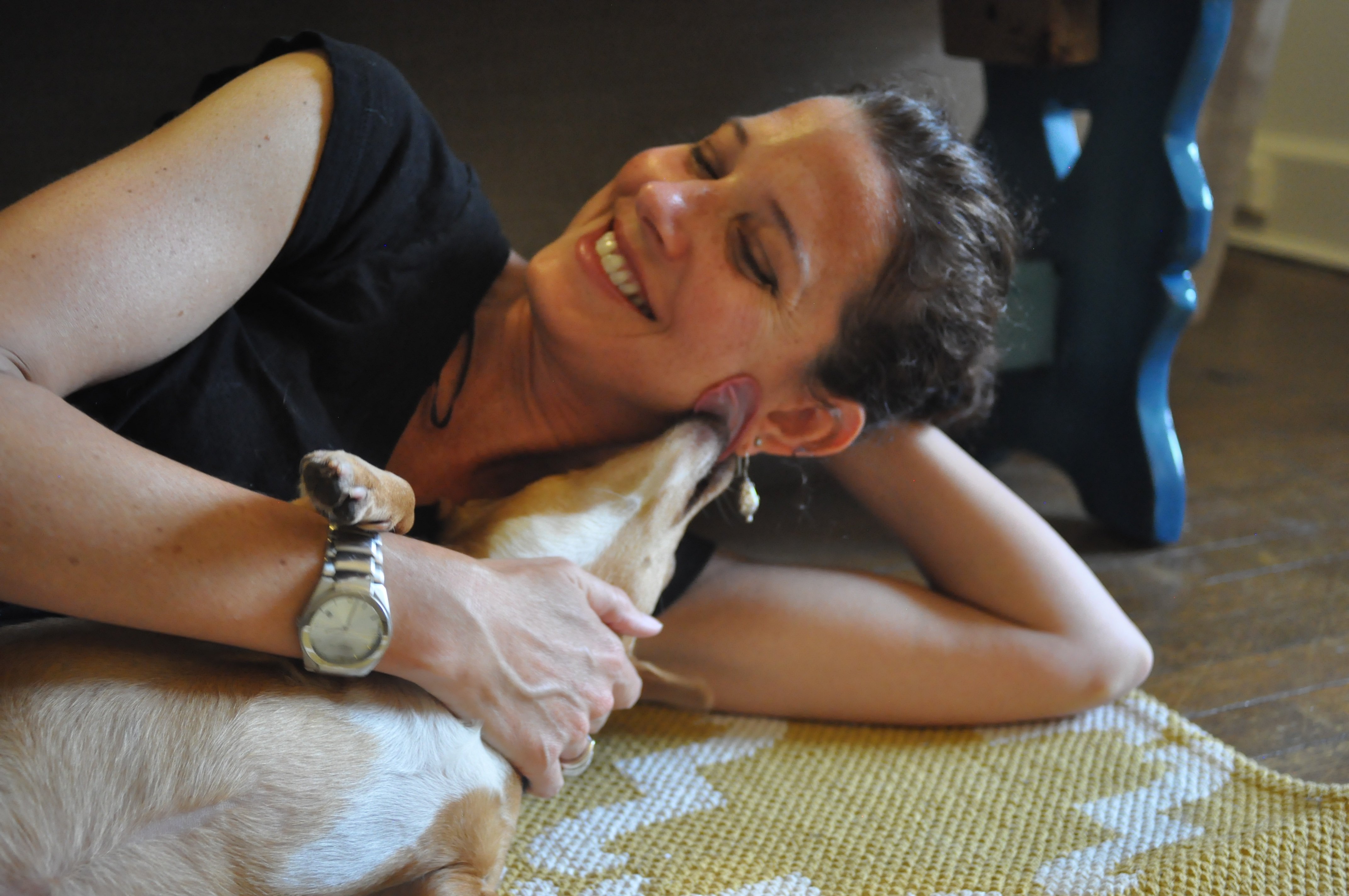 Elena, the adorable dog who was reacued by CAP, hangs out at her new home with PETA staffer Rachel Bellis.