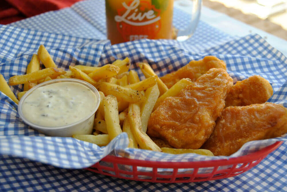 Gardein Fishless Filets with french fries in a red basket