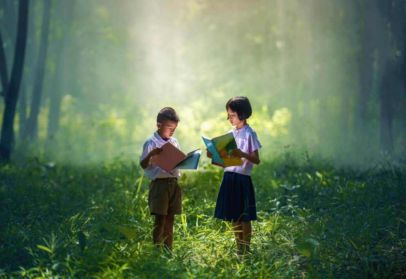 Two kids reading in forest