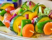Colorful vegetable skewers with carrots, peppers, tomatoes, etc.