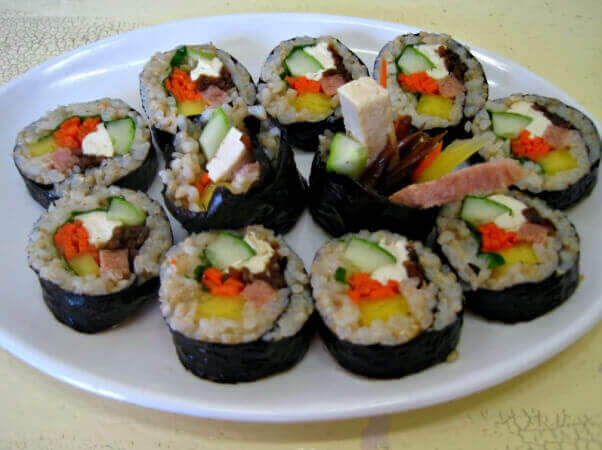 white plate with vegan kimbop sushi