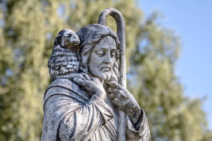 Statue of Jesus holding a staff and a lamb.