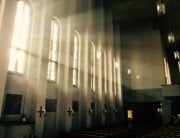 Dark church with light shining through windows