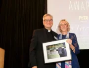 Fr. Terry Martin and Ingrid at award ceremony